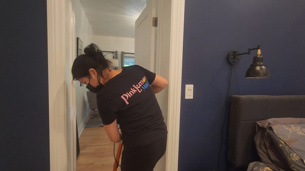 Maid in Vancouver cleaning in a hallway